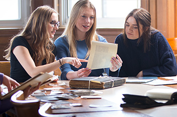 Students looking through old archives